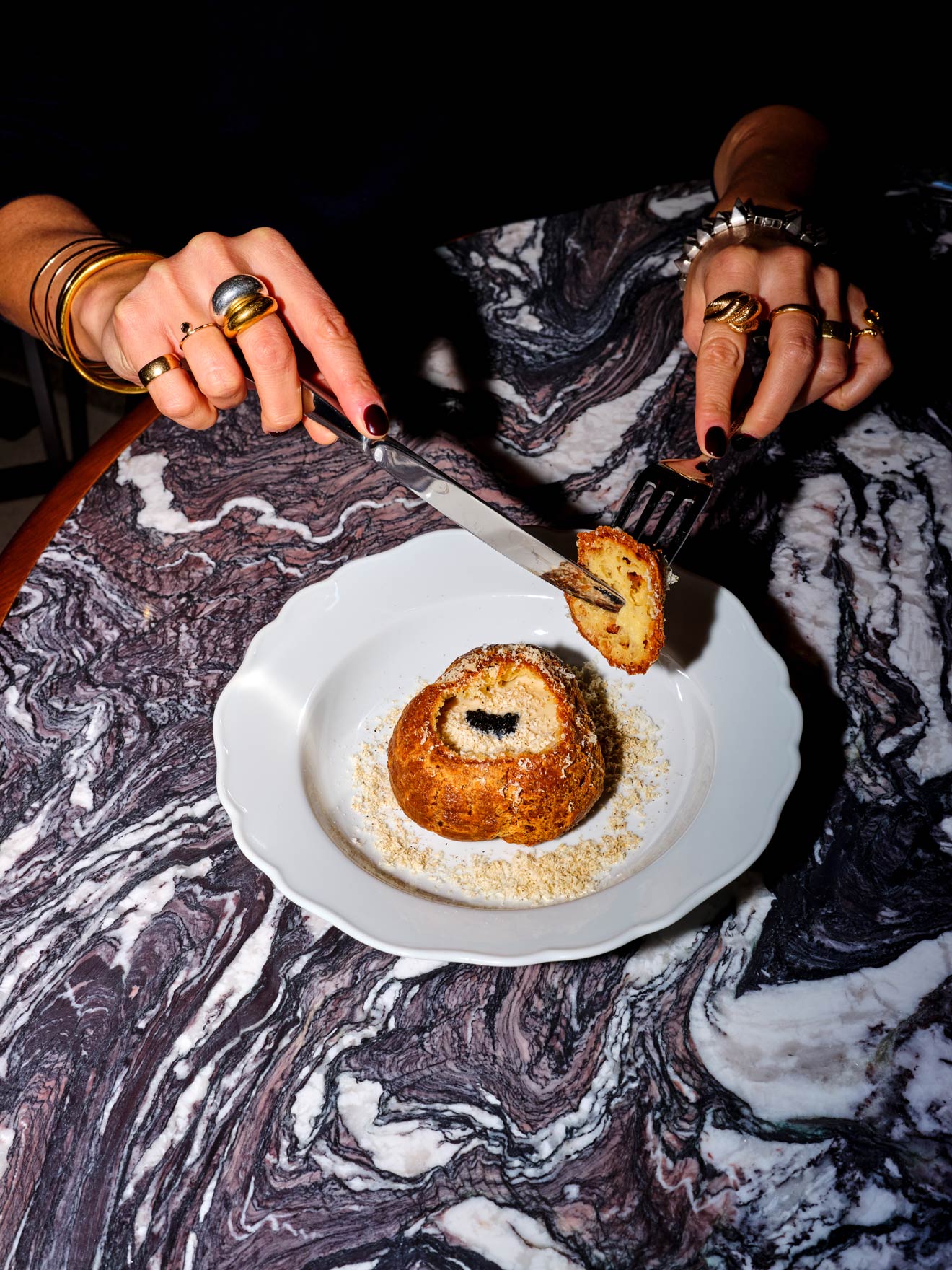 Woman cutting into a breaded dessert